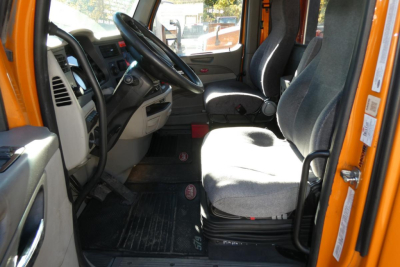 Peterbilt 579 truck interior cab view showing driver seat and passenger seat with dashboard and steering wheel.