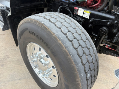 Mack GR64F front wheel showing large dual rear? No, front steer axle with Graber? The tire reads GRA... The wheel and tire assembly with hub and lug nuts visible.