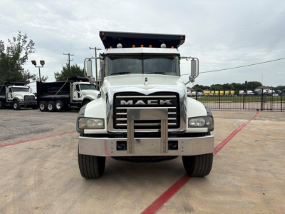 Front view of a white 2020 Mack GR64F dump truck showing the grille with MACK letters and bumper guard.