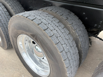 Mack GR64F dump truck rear dual wheels showing tread pattern and wheel rims.