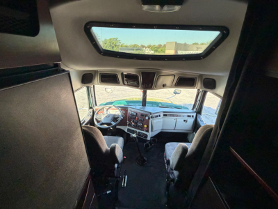 Driver seat area and dashboard of a 2017 Western Star 5700XE conventional sleeper truck cockpit