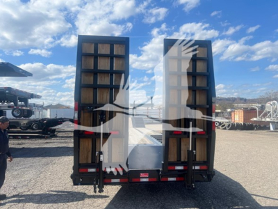 Rear view of a Dorsey drop deck trailer showing two fold-up ramp doors, black chassis, and red and white reflective markings.