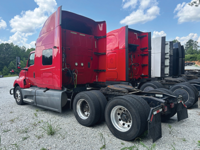 2019 International LT625 tractor side/back view showing red sleeper cab and dual rear axles.