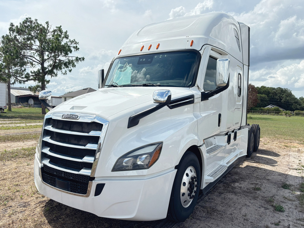2021 Freightliner Cascadia126 sleeper cab truck front-left view showing grille, headlights, and white exterior