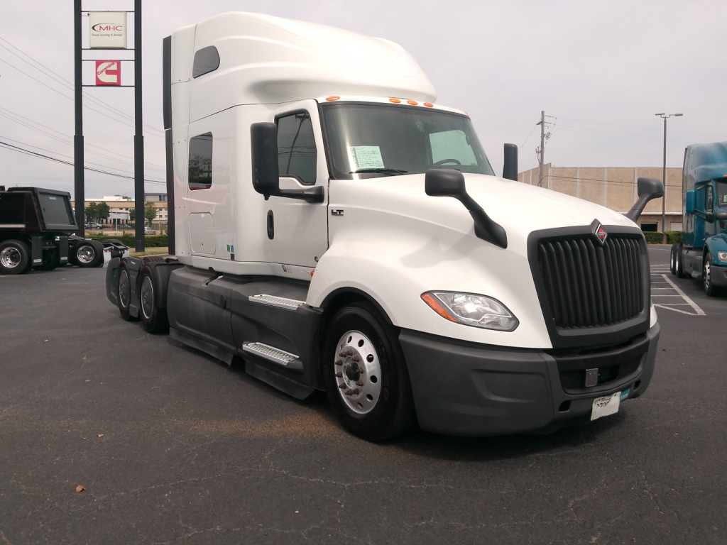 Truck: 2023 International LT625 conventional sleeper tractor in white, front three-quarter view.
