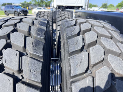 Mack GR64B chassis image showing dual rear tires and tread pattern.