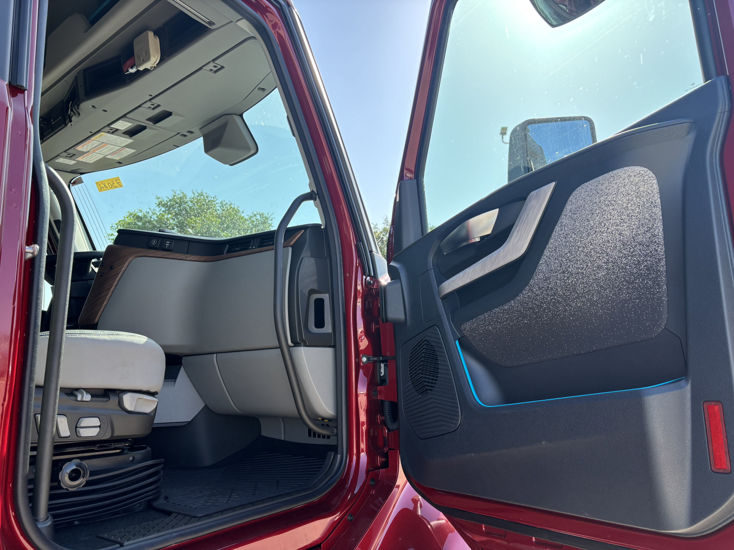 Volvo truck cab interior entry showing door panel and steering area