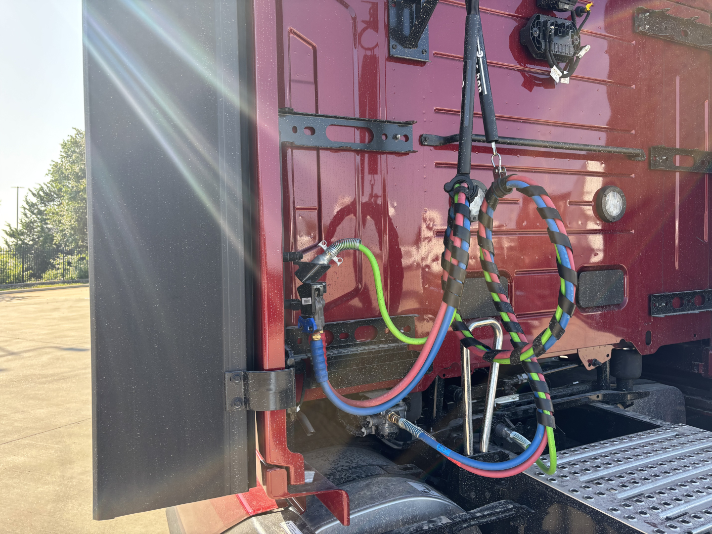 Volvo VNL64T860 chassis rear showing multiple colored air lines and electrical cables connected near sleeper cab area.