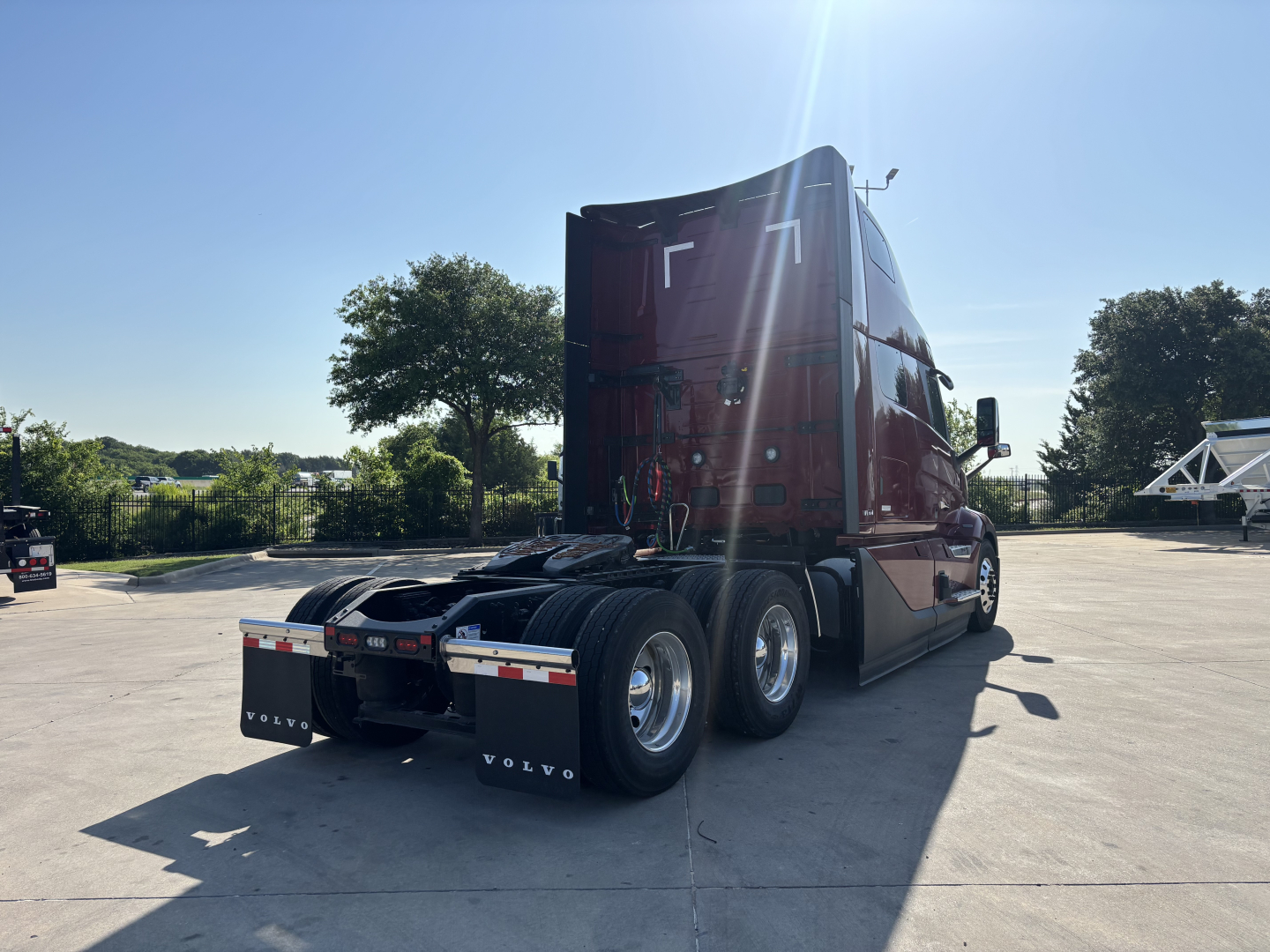 Volvo VNL64T860 truck tractor rear view showing sleeper cab and dual rear axles.