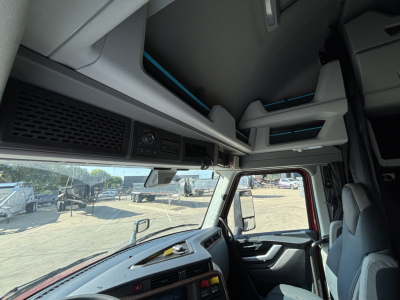 Volvo VNL64T860 cab interior showing overhead storage panels and dash area.