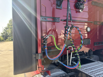 Volvo VNL64T860 chassis rear showing multiple colored air lines and electrical cables connected near sleeper cab area.