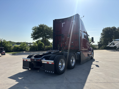 Volvo VNL64T860 truck tractor rear view showing sleeper cab and dual rear axles.