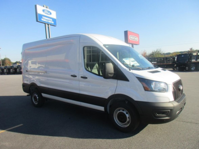 Ford Transit cargo van in a dealership lot showing side and front view with white body and black bumper, windows, and wheels.