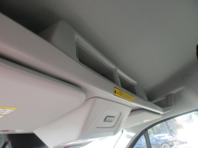 Front interior roof area of a 2026 Ford Transit cargo van showing overhead console and air vent; no visible text on component; portion of window and dashboard visible.