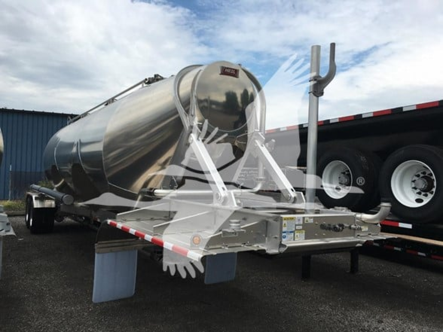 Heil cementer trailer showing polished cylindrical tank and rear mounting frame with support legs.