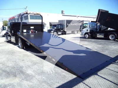 Truck rollback equipment with extended flatbed ramp in service yard; MV International with VIN 1HTEUMML9NH326722 and stock T26722.