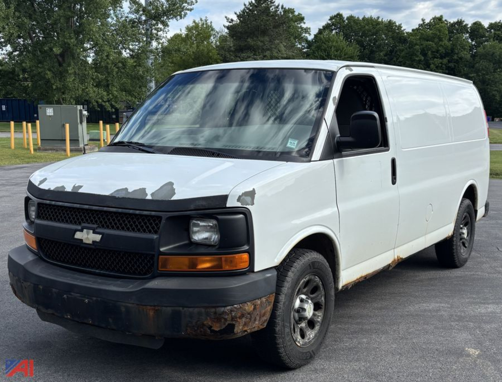 Chevrolet Express cargo van showing front grille with bowtie emblem and headlights in an in-service exterior condition