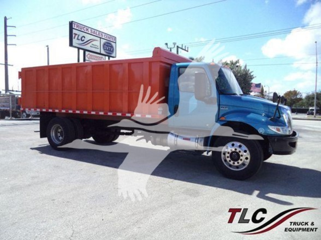 Dump truck with blue cab and orange dump body in a parking lot, VIN 3HAEUMML3LL051680 on listing, TLC watermark across image.