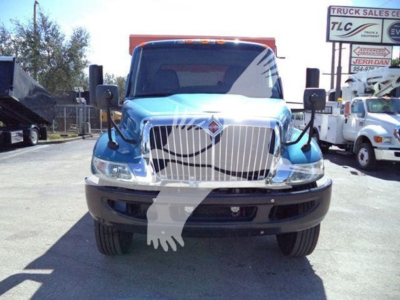 Front view of a blue 2020 International MV dump truck showing grille, headlights, and front bumper with large side mirrors.
