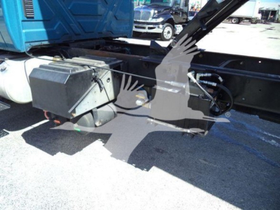 Truck chassis side view showing battery box and hydraulic reservoir under the cab of a 2020 International MV dump truck.