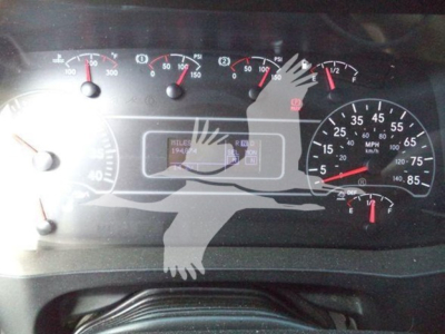 Dashboard view of a 2020 International MV dump truck showing gauges incl. speedometer, tachometer, and warning indicators.