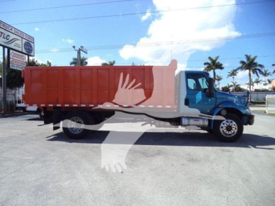 Dump truck with blue cab and orange dump body, long wheelbase, palm trees in background, stock number T51680 visible.