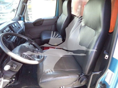 Interior of a 2020 International MV dump truck cab showing driver's seat and steering wheel, with visible dashboard controls and passenger seat.