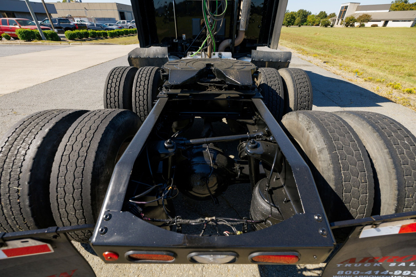 Peterbilt 579 chassis and rear section showing dual rear axles and fifth-wheel mounting area with components and wiring.
