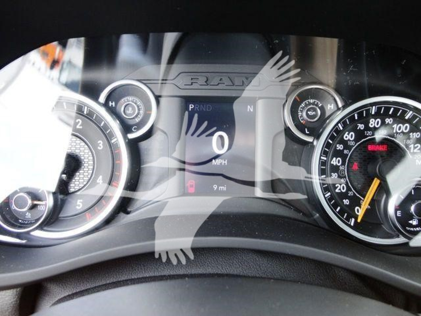 Ram 4500 dashboard cluster showing speedometer, tachometer, and central digital display with PRND and 0 MPH, 9 miles, and warning icons visible.