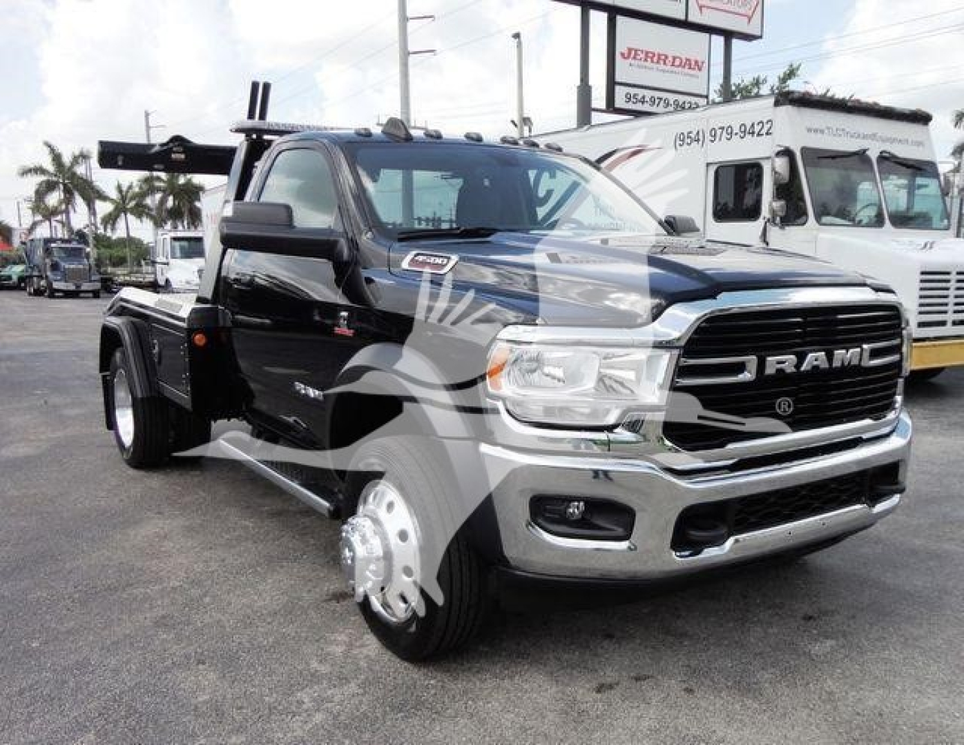 Ram 4500 heavy-duty truck front view with winch setup and chrome grille; visible badges include RAM on grille and 4500 series; black body with dual rear wheels and winch hardware at the back.