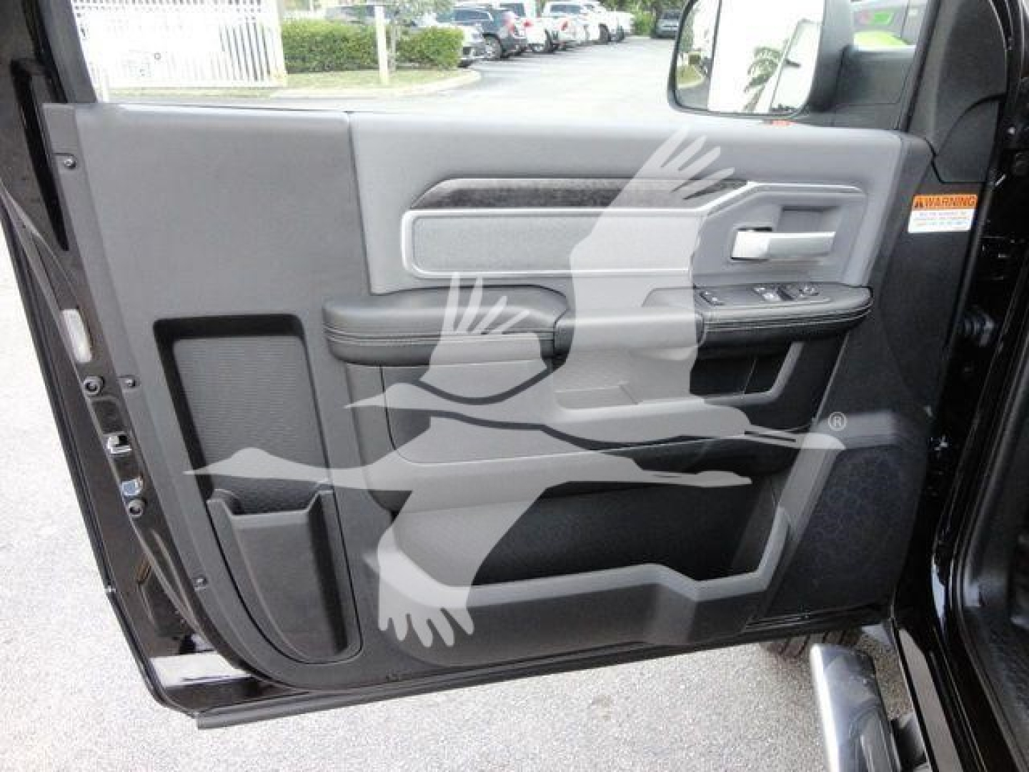 Ram 4500 HD SLT door panel view with armrest, chrome trim, and storage pockets.