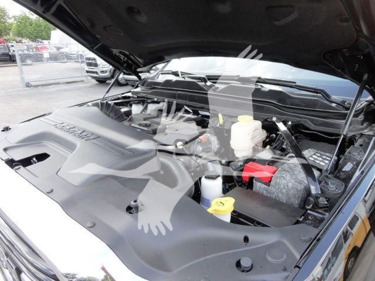 Ram 4500 HD SLT engine bay showing coolant reservoir, brake fluid reservoir, and engine components under open hood.