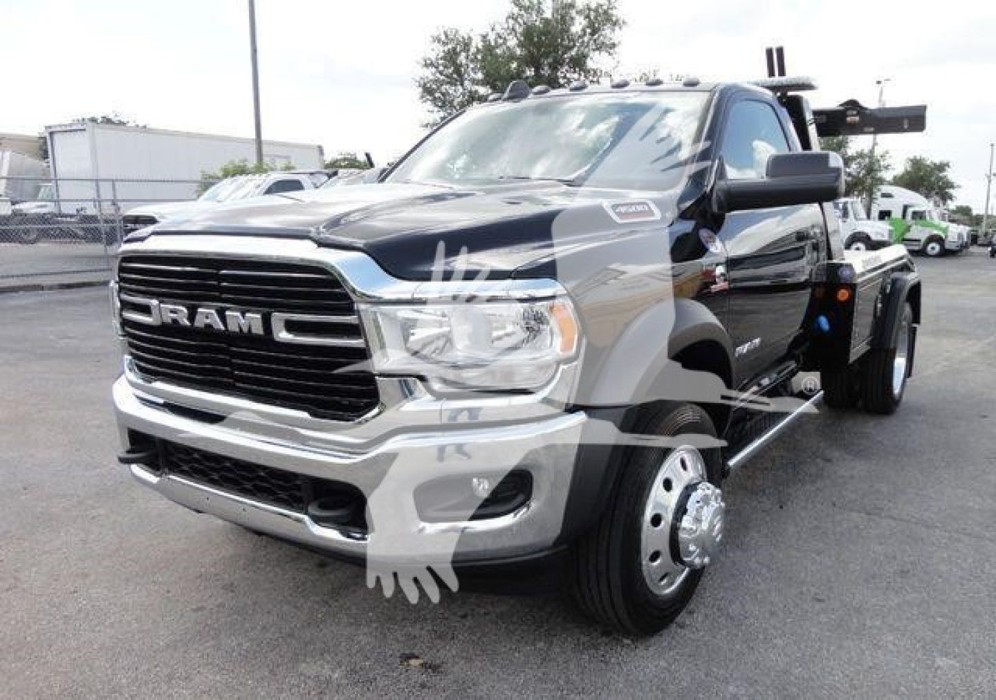 Ram 4500 HD Ram head logo front grille with large front wheels and winch equipment on bed. visible text includes RAM on grille.
