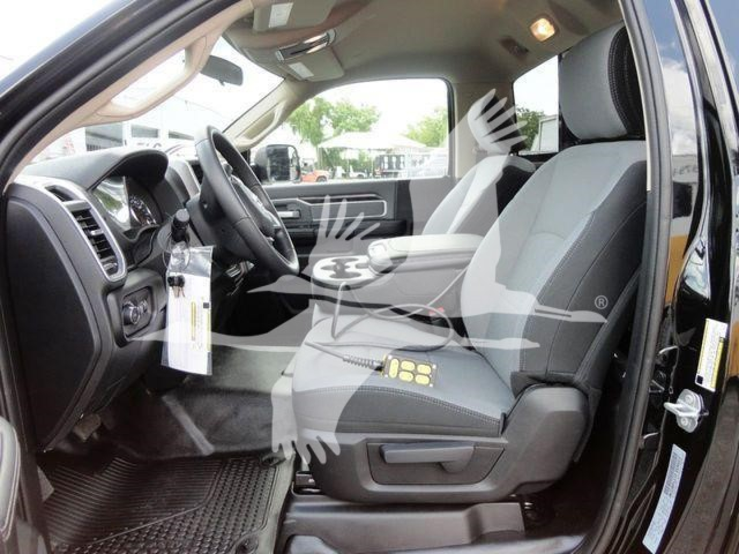 Ram 4500 HD SLT interior view showing front seats, steering wheel, and dashboard with tag hanging from steering column.