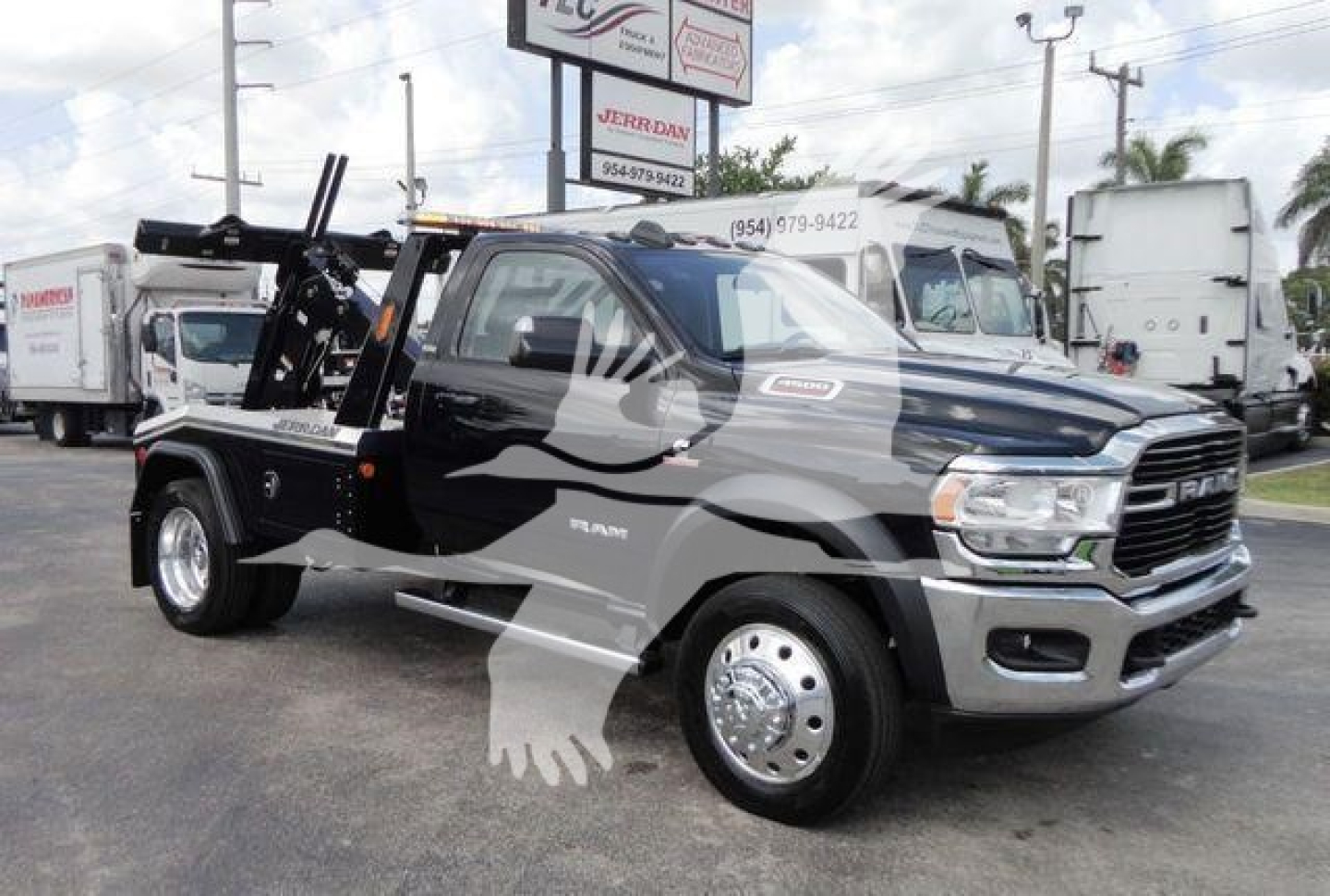 Ram 4500 heavy duty tow truck in black with chrome grille and winch setup, side view showing cab and wheel design.