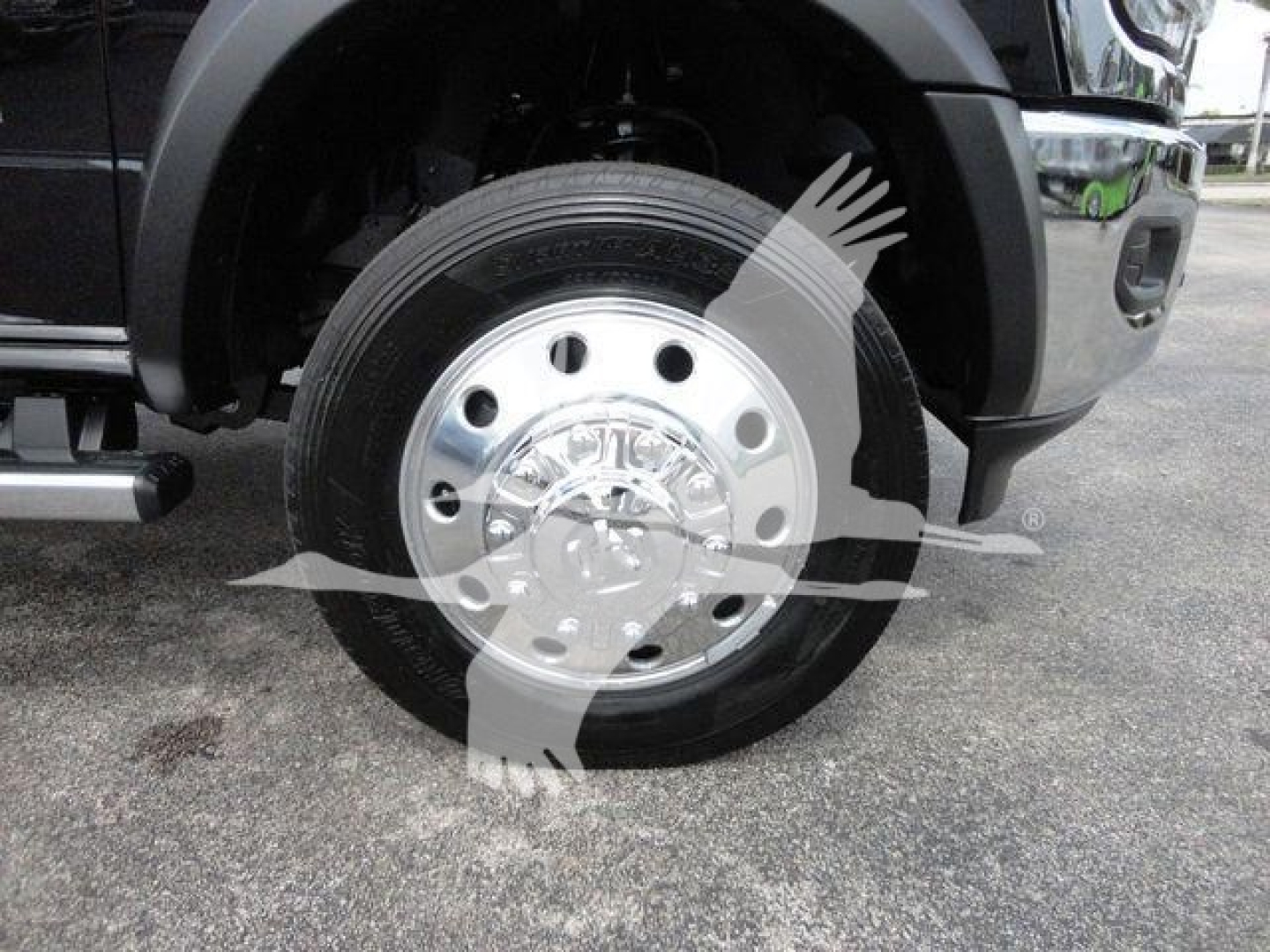 Front wheel and fender of a Ram 4500HD SLT truck showing polished wheel with hubcap and tire tread.
