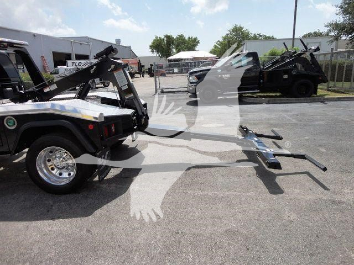 Ram 4500HD SLT truck with tow hitch and winch equipment attached, side view in dealership lot.