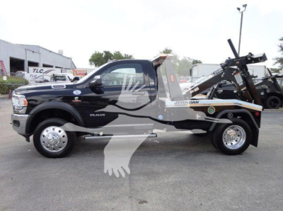 Ram 4500 rear-tilt tow truck side view showing black and gray wrap, 'RAM' badge, chrome wheels, winch apparatus in bed, stock number J68842.