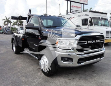 Ram 4500 heavy-duty truck front view with winch setup and chrome grille; visible badges include RAM on grille and 4500 series; black body with dual rear wheels and winch hardware at the back.