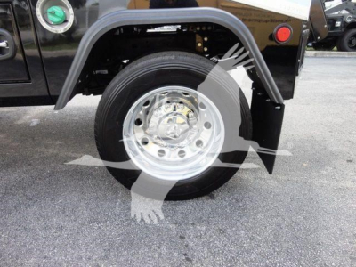 Wheel area of a Ram truck with a chrome wheel, fender flare, and black body; visible are the tire and wheel, along with portion of fender and rear area.