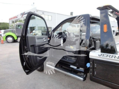 Ram 4500 HD SLT pickup/crew cab with open driver door, showing winch-equipped bed and side step in a dealership lot.