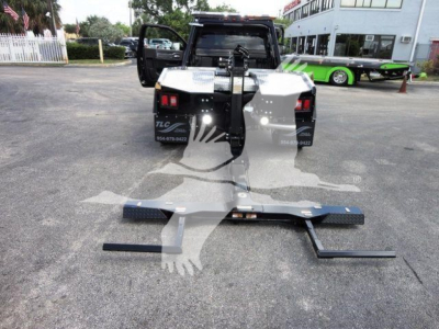 Ram 4500 HD SLT front view with a winch setup and mounting bar in a dealership lot.