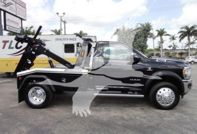 Ram 4500 heavy-duty tow truck in black showing winch attachment and side profile with RAM badge and wheel covers.