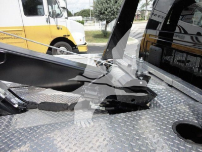 Ram 4500 HD SLT winch truck bed showing winch mechanism and diamond plate surface.