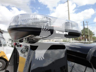 Truck winch light bar with WHELEN branding mounted on a Ram 4500 HD SLT vehicle, visible lens and mounting structure.