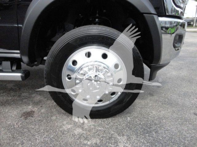Front wheel and fender of a Ram 4500HD SLT truck showing polished wheel with hubcap and tire tread.