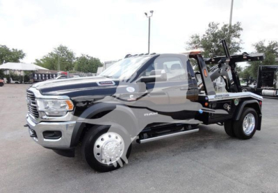 Ram 4500 pickup truck in service truck configuration with tow/winch equipment, showing Ram badges and wheel, side step, and black body with chrome grille.