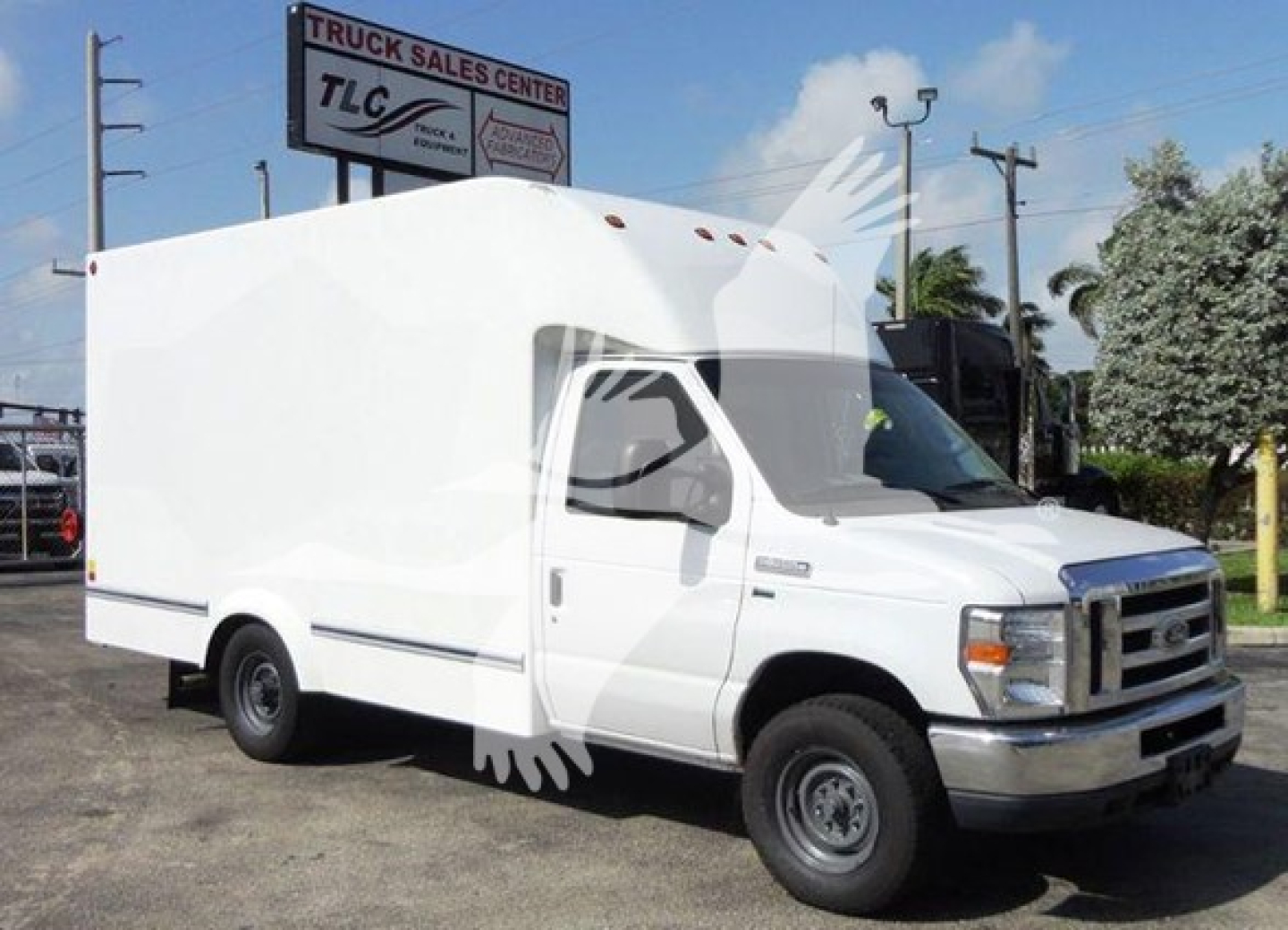 Ford E-350 cargo van in utility yard showing white box truck body and cab with Ford grille