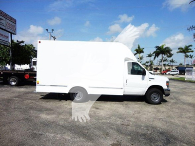 Large white Ford E-Series cargo van side view showing high cube box and cab; no visible branding or text.