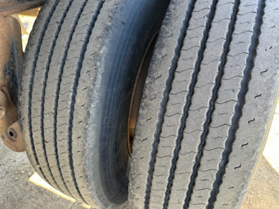 Trailer wheel tires showing tread detail on a utility spread air combo flatbed.
